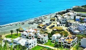 Discover Jnan Nich Beach, a hidden black sand paradise in northern Morocco. Crystal clear waters, dramatic cliffs, and authentic Berber culture await.
