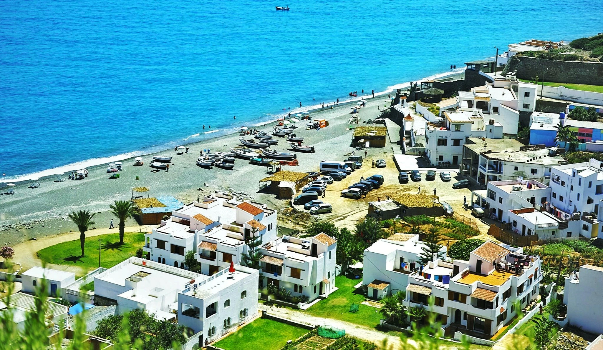 Discover Jnan Nich Beach, a hidden black sand paradise in northern Morocco. Crystal clear waters, dramatic cliffs, and authentic Berber culture await.