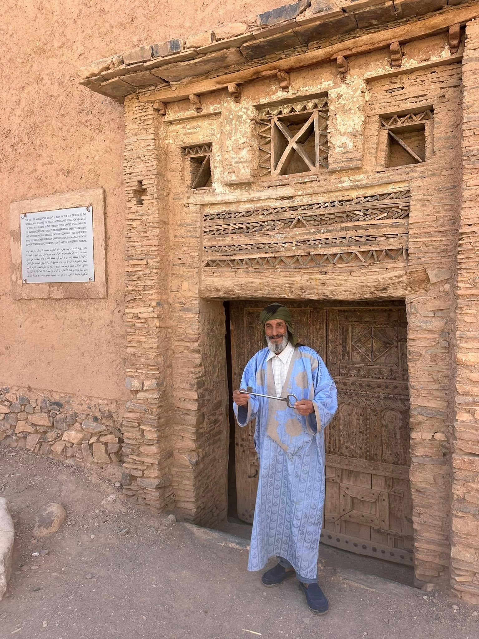 The Aït Kine collective granary is an 18th-century communal storage facility near Tata, Morocco, that serves as both a historical monument and active community center. This traditional agadir features fortress-like architecture with three levels of storage compartments around a central courtyard, built using palm tree trunks adapted to desert conditions. Beyond storage, it hosts village weddings, religious ceremonies, and gatherings, keeping Amazigh Berber traditions alive for travelers seeking authentic Moroccan heritage experiences.